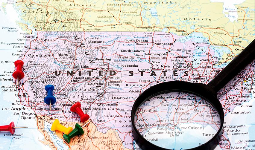 A map of the United States with a magnifying glass on it.