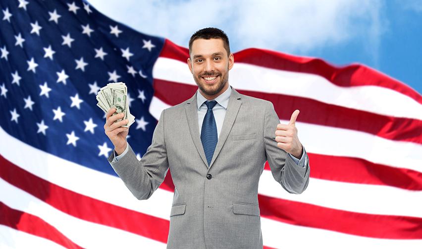 A service provider holding immigrant investor capital in his hand, in front of an American flag.