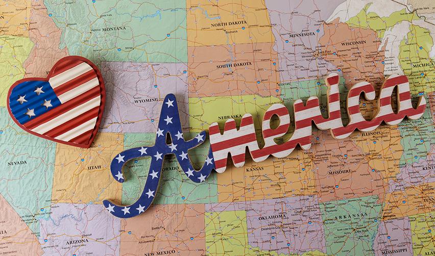 A close-up of a United States map with the word America on it in American flag colors.