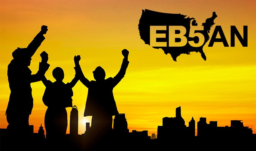 A silhouette of happy people with their arms raised in the air in the sunset, with the EB5AN logo on the side.