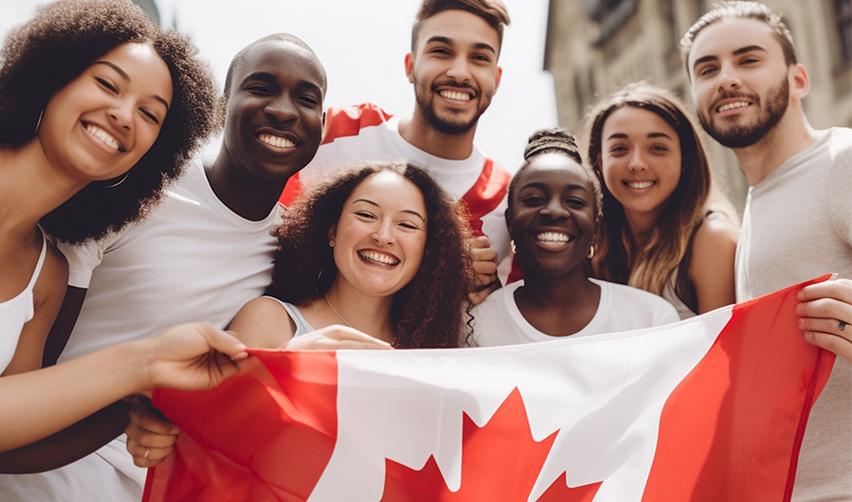 A group of Canadian nationals holding up a Canadian flag.