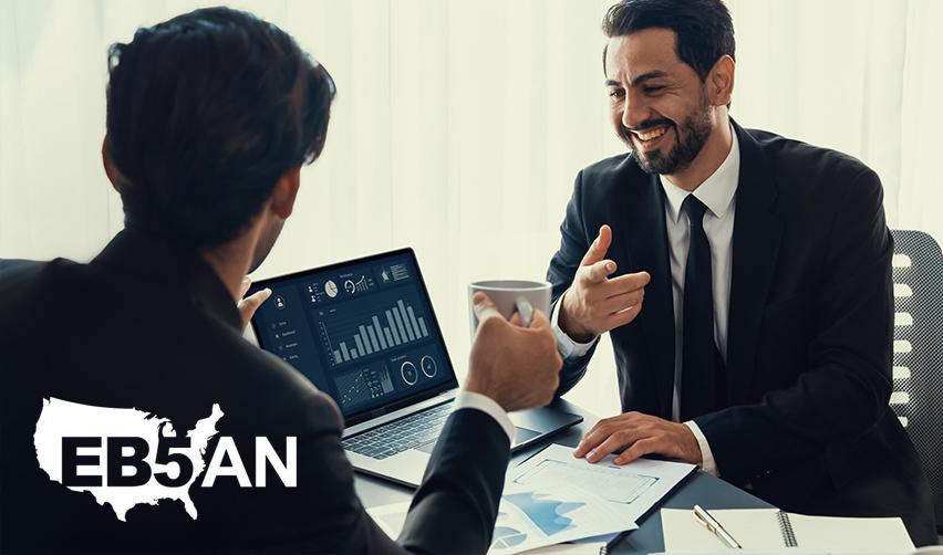 An EB-5 investor talking to an EB-5 expert at an office, with the EB5AN logo on the corner.
