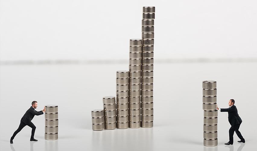 Several stacks of coins and two investors pushing them in different directions, symbolizing partial regional center investments.