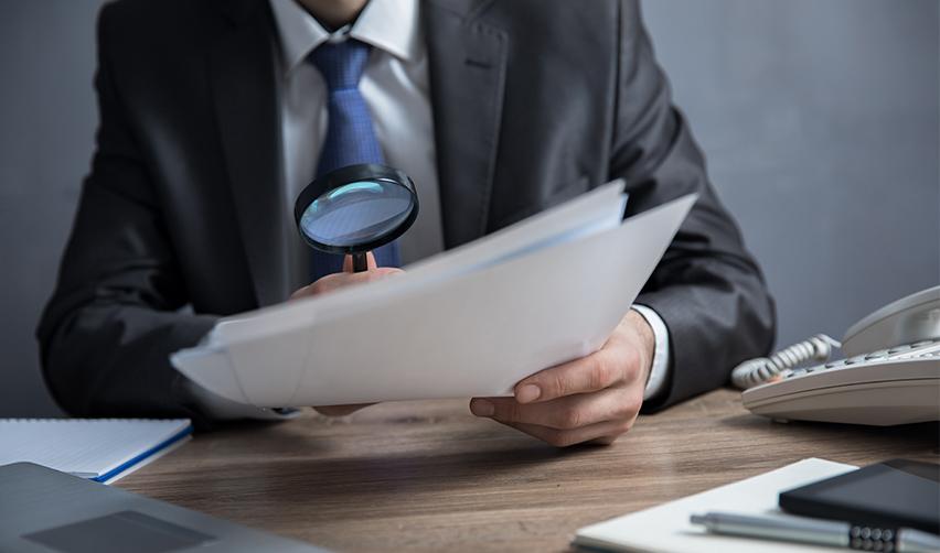 An EB5 expert or immigration law professional examining some employment based adjustment of status documentation.