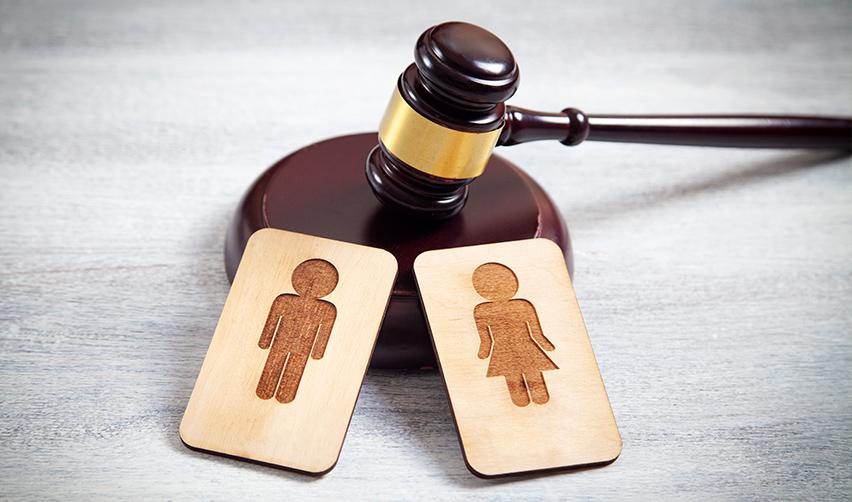 A gavel and wooden cards with a person symbols on them, referring to eb5 divorce cases.