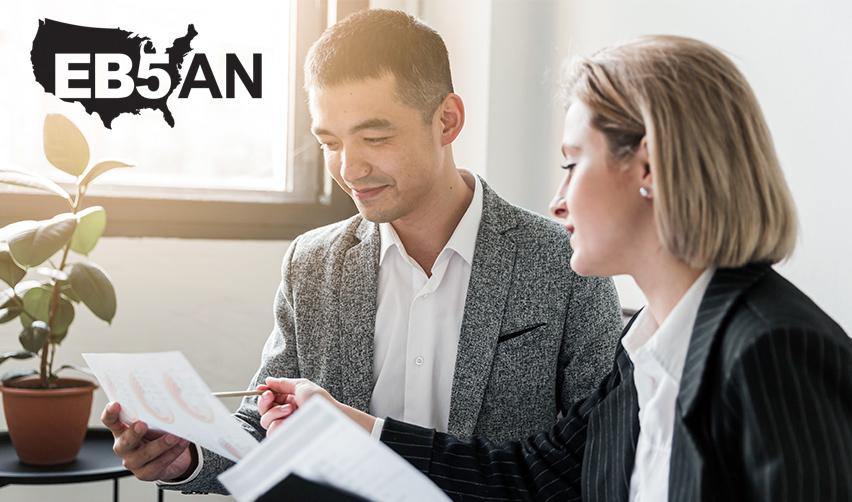 An EB5 regional centers managing partner examining an adjustment of status application with an EB5 investor, under the EB5AN logo.