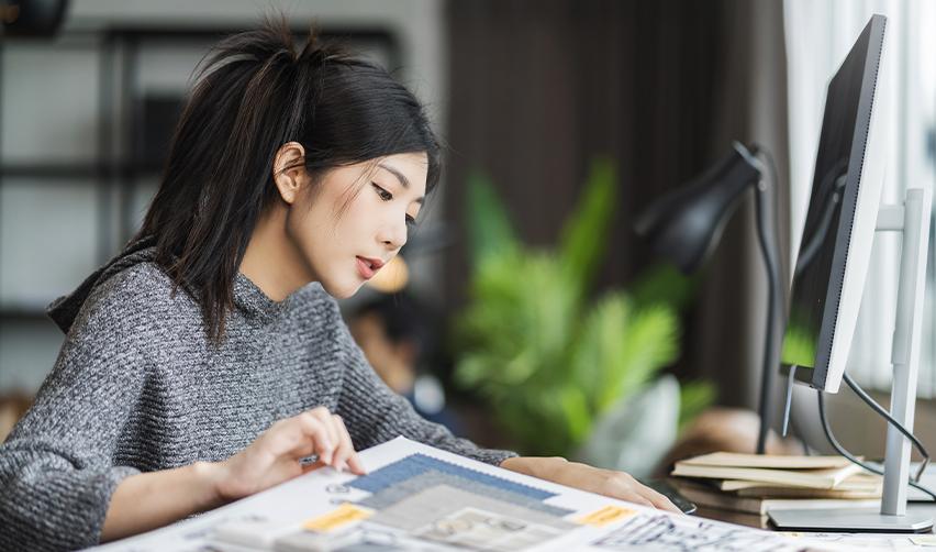 An EB5 dependent family member studying in front of a computer.