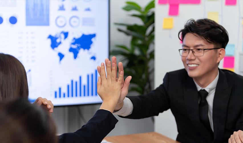 Direct investors in an E-2 visa giving each other a high five.