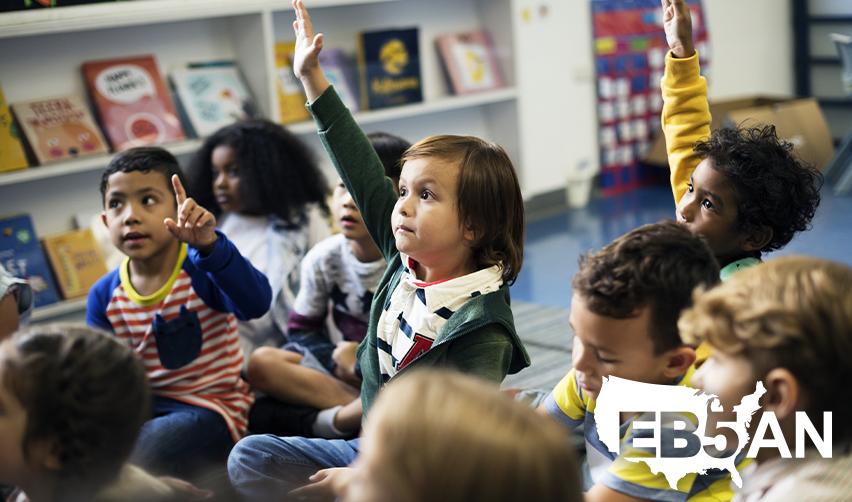 Children of EB5 investors in a classroom, benefiting from U.S. education opportunities, with the EB5AN logo on the corner.
