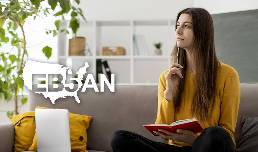 An EB5 investor sitting next to the EB5AN logo and thinking with a notebook and pen in her hand about her conditional permanent resident application.