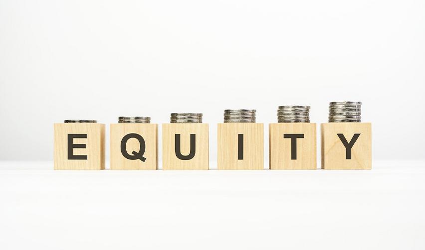 Wooden blocks that spell out equity under stacks of coins.