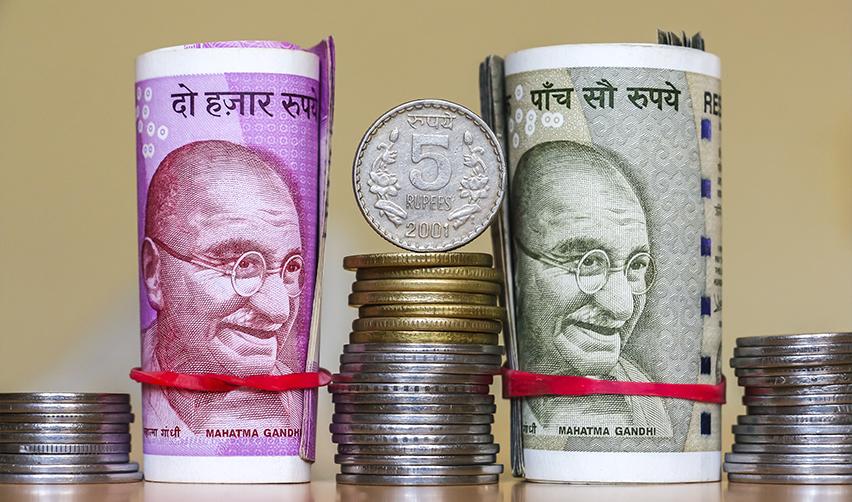 Stacks and coins of Indian currency, symbolizing EB5 capital investment.