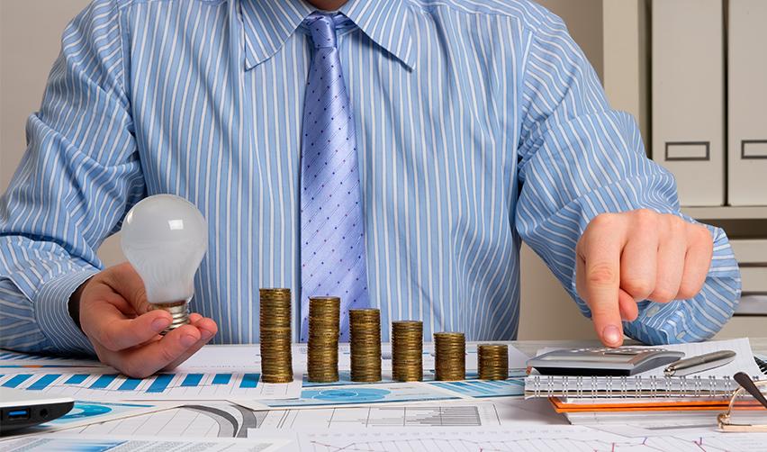 An EB5 investor calculating his capital investment on a desk at an office.