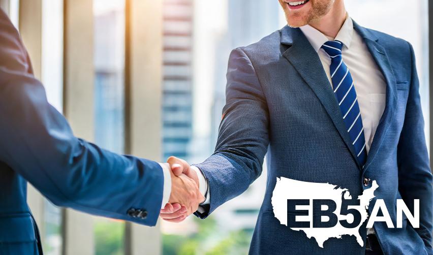 An EB5 investor shaking hands with a regional center managing partner, with the EB5AN logo on the corner.