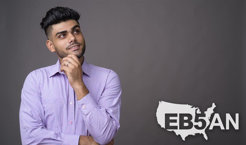 An alien entrepreneur posing next to the EB5AN logo.