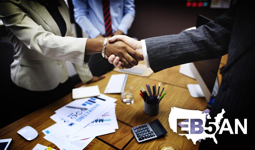An EB5 regional center principal shaking hands with an alien entrepreneur, with the EB5AN logo on the corner.