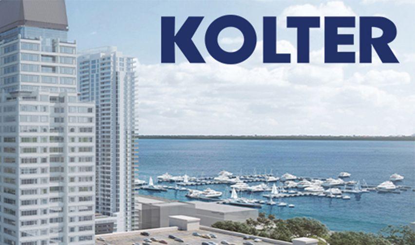 A tall building next to a body of water