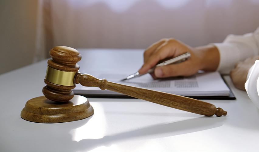 An immigration judge or attorney going over some policy update documents with a gavel on the desk.
