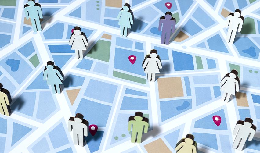 A map with location pins dropped on them and paper cutouts of EB5 investors.