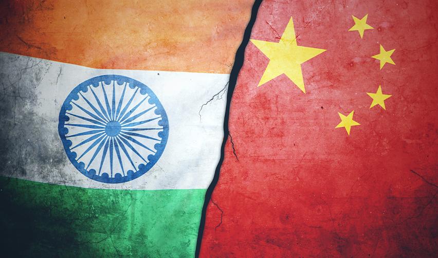 Flags of India and China with a symbolic crack, representing the impact of visa backlogs and retrogression on EB5 investors from these countries.