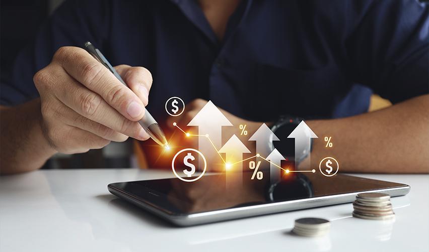 A close-up of a business professional analyzing profitability indicators with a digital tablet, emphasizing the importance of selecting financially secure EB5 projects to avoid delays.