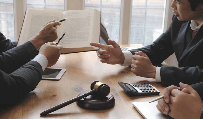 A group of immigration attorneys or EB5 investors discussing a writ of mandamus case at an attorney's office.