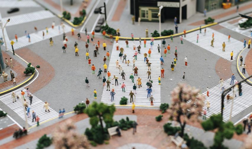 A model of a busy street, symbolizing EB5 urban TEAs, with human figurines on it.