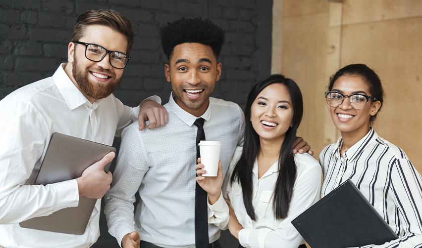 A group of employees with specialized knowledge or skilled workers celebrating their switch from L1 visa to green card.