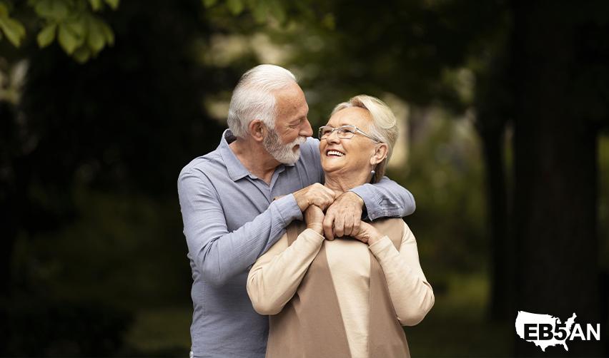 A happy senior couple enjoying outdoor time together with the EB5AN logo on the corner, symbolizing the retirement lifestyle flexibility offered by the EB5 visa.