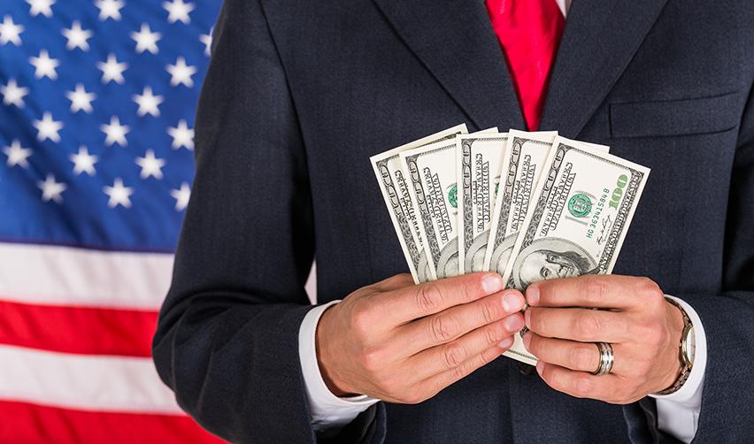 An alien entrepreneur holding some U.S. dollars, symbolizing a green card through investment in America.