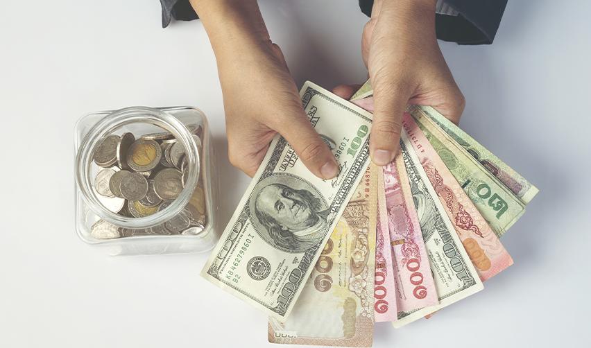 A prospective Eb5 investor holding some money in their hands, symbolizing the eligibility criteria to turn their L1 visa to green card.