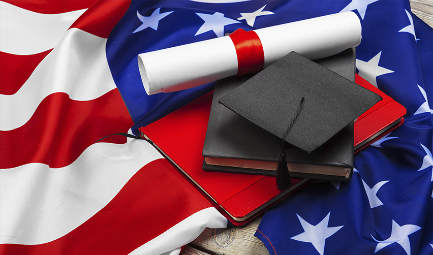 U.S. flag with graduation cap, diploma, and books symbolizing education, career, and opportunities through the EB5 immigrant investor program.