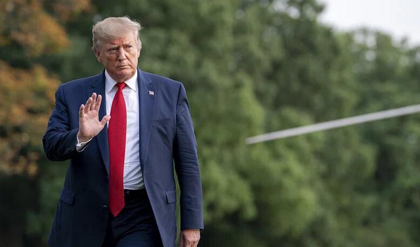 President Donald Trump walking outdoors, representing possible stricter immigration policies that may impact H1B visa holders and highlight the benefits of the EB5 program.