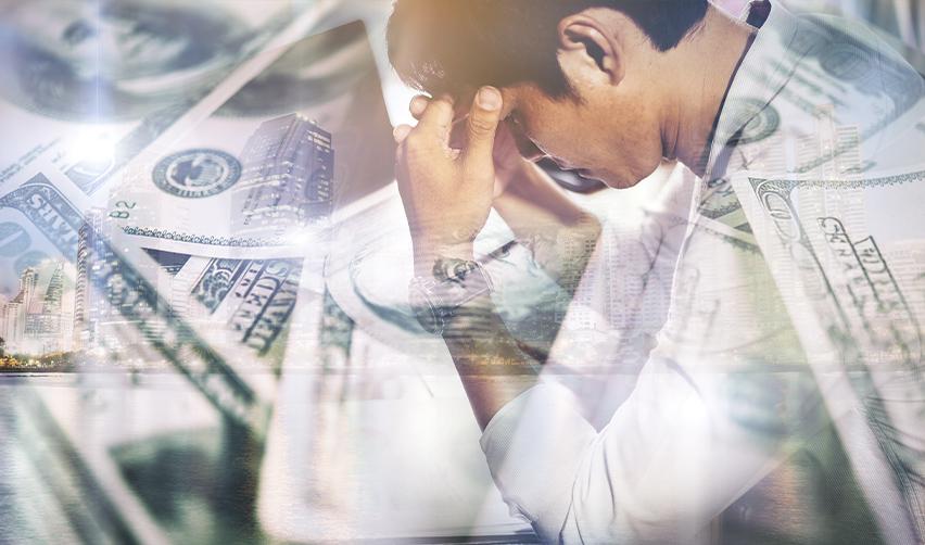 Frustrated man with financial overlays, symbolizing challenges with proving lawful source of funds or investment issues in the EB5 visa process.