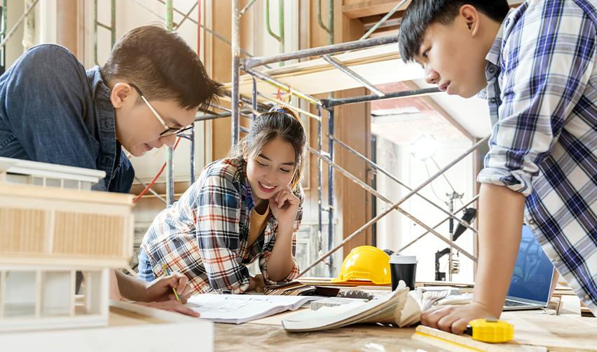 International students working in a STEM field during OPT, discussing career opportunities and the EB5 pathway to a Green Card.