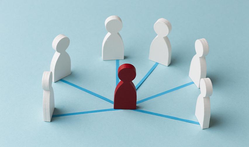 A central red figure connected to others, symbolizing the support network needed for green card holders to establish themselves as lawful permanent residents.