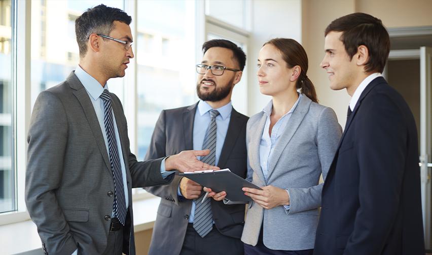 Business professionals having a discussion in a modern office, highlighting employment based green card pathways in the US.