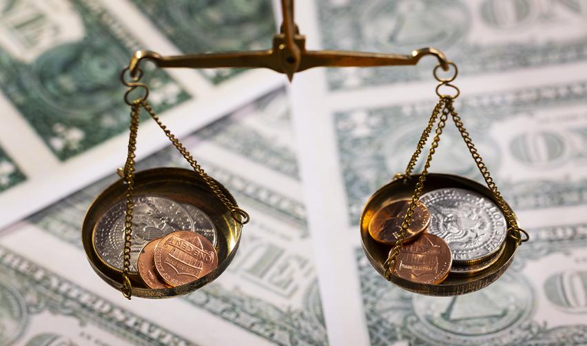Financial scales representing the funding options for H1B visa holders interested in meeting the EB5 investment requirements for U.S. permanent residency.