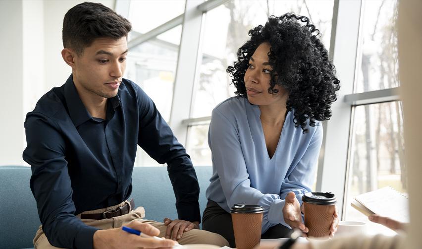 A focused discussion between two individuals planning EB5 investment strategies, highlighting the importance of expert guidance in the EB5 program.