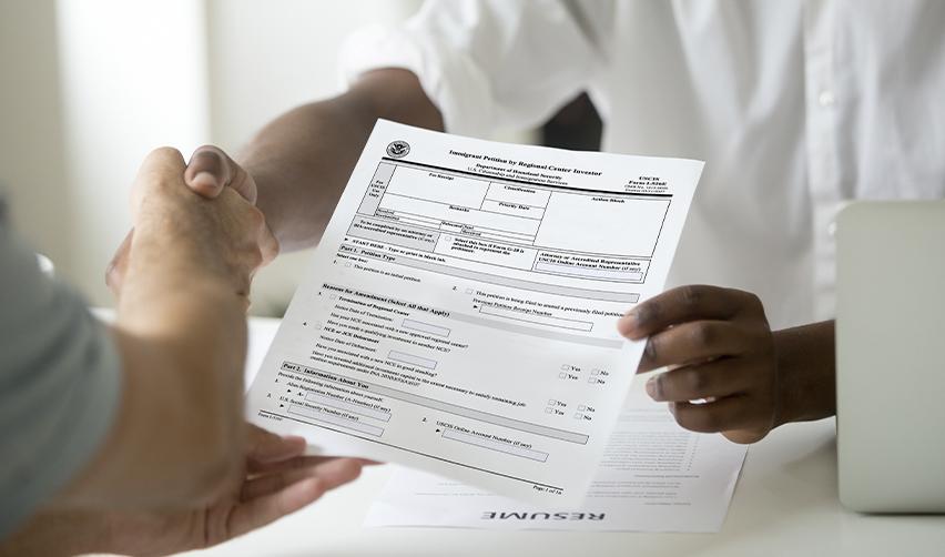 An applicant submitting an EB5 Immigrant Investor petition form for U.S. permanent residency, emphasizing the importance of accuracy in filing.