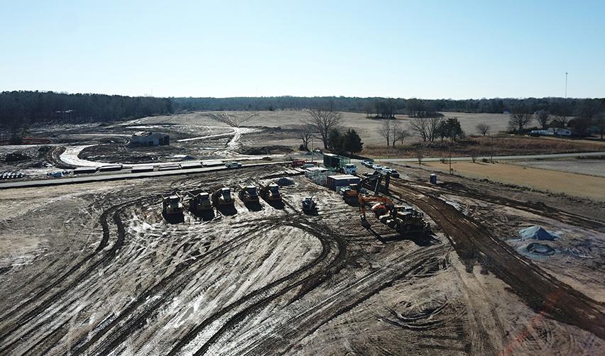 An aerial view of the Rocky River rural eb5 project construction site, showcasing heavy machinery and progress in building the EB5 project development.