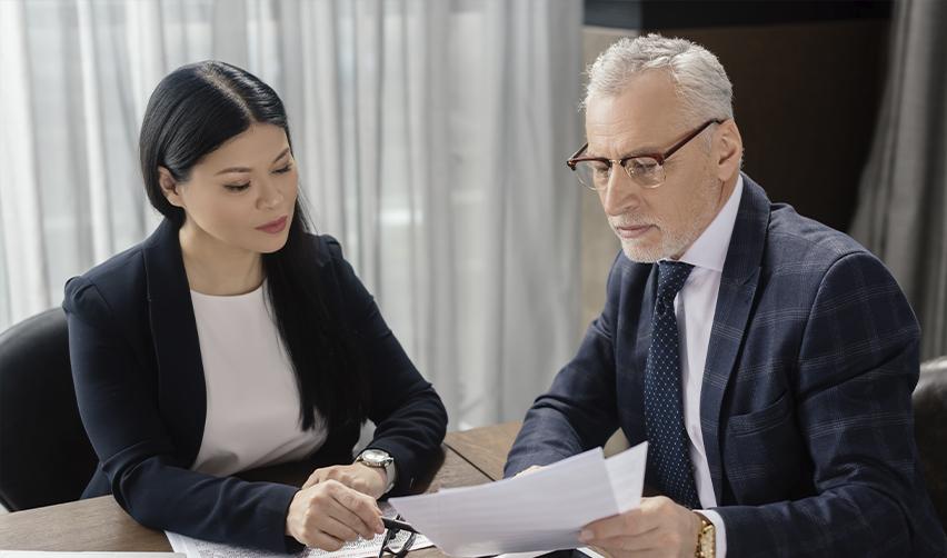 A professional consultation between an experienced EB5 attorney and an EB5 investor reviewing immigration documents.