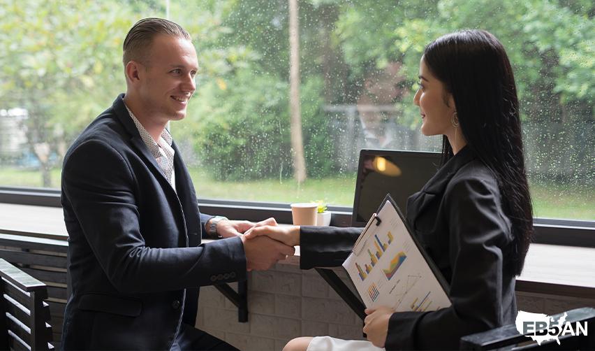 A regional center industry professional shaking hands with an EB5 investor.