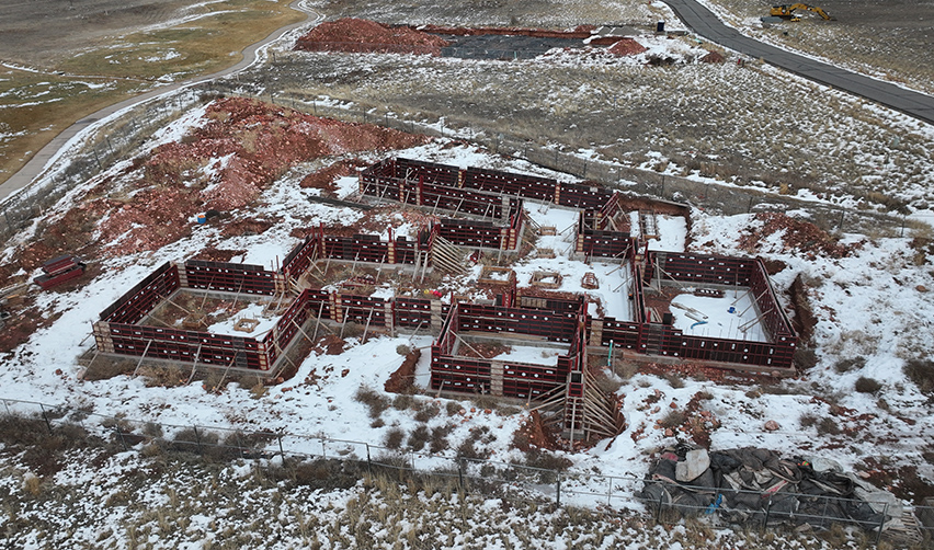 A construction site with snow on the ground