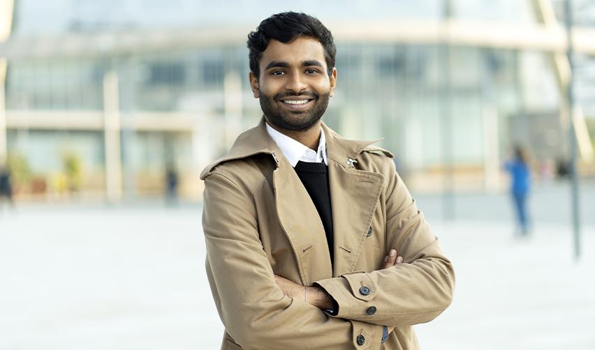 Confident Indian entrepreneur standing outdoors, representing the opportunities available through the EB5 Immigrant Investor Program.