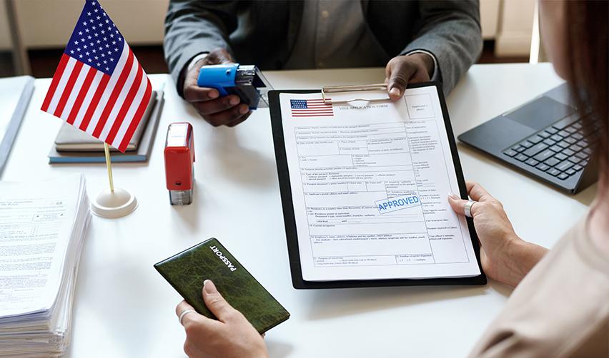 Close-up of a visa application form with approval stamp, highlighting the EB5 visa's secure path to U.S. residency.