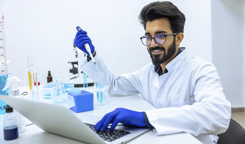 Indian scientist working in a laboratory, highlighting the contributions of EB1, EB2, and EB3 applicants to the U.S. workforce.