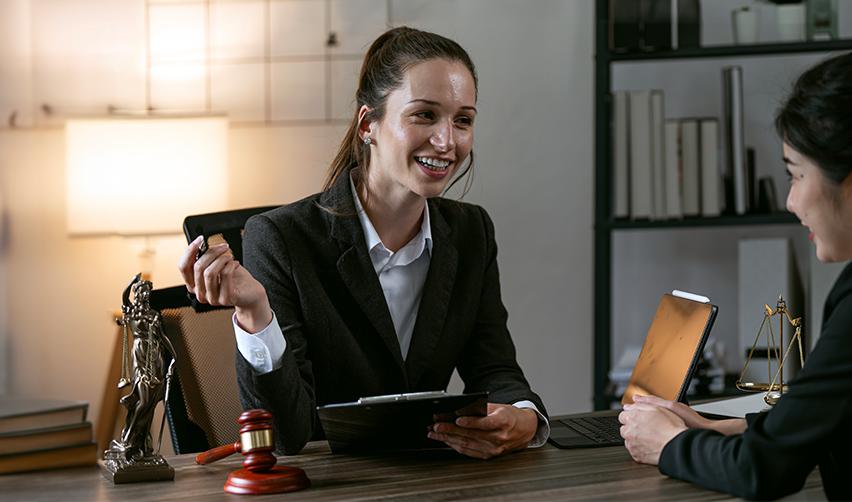 An experienced immigration lawyer smiling during a consultation, emphasizing the importance of selecting the best lawyers for EB5 visa success.