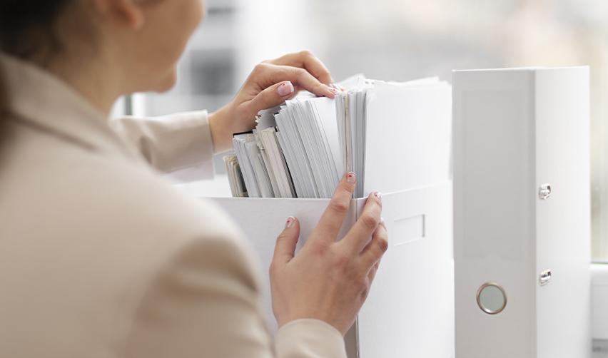 An immigration lawyer organizing immigration documents, representing preparation for EB5 applications amidst potential backlogs in setaside visa categories. Act now to avoid delays in the EB5 process.