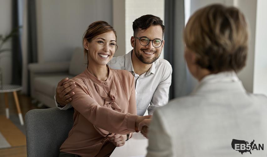 The EB5AN logo next to a happy couple smiling and shaking hands with an advisor or regional center professional, symbolizing trust and collaboration during the EB5 visa process.